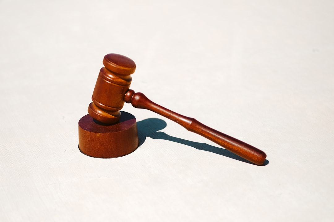 A wooden gavel placed on a round base, symbolizing legal proceedings