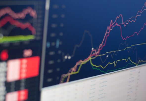 Close-up of a screen displaying financial graphs and data trends in vibrant colors.