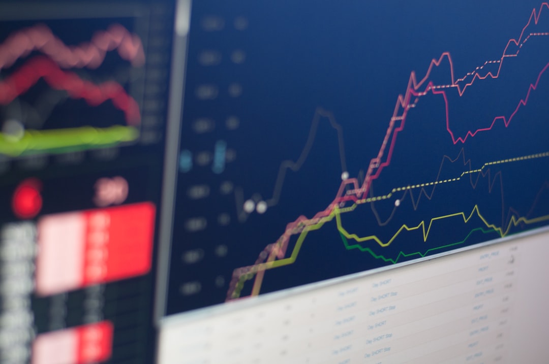 Close-up of a screen displaying financial graphs and data trends in vibrant colors.
